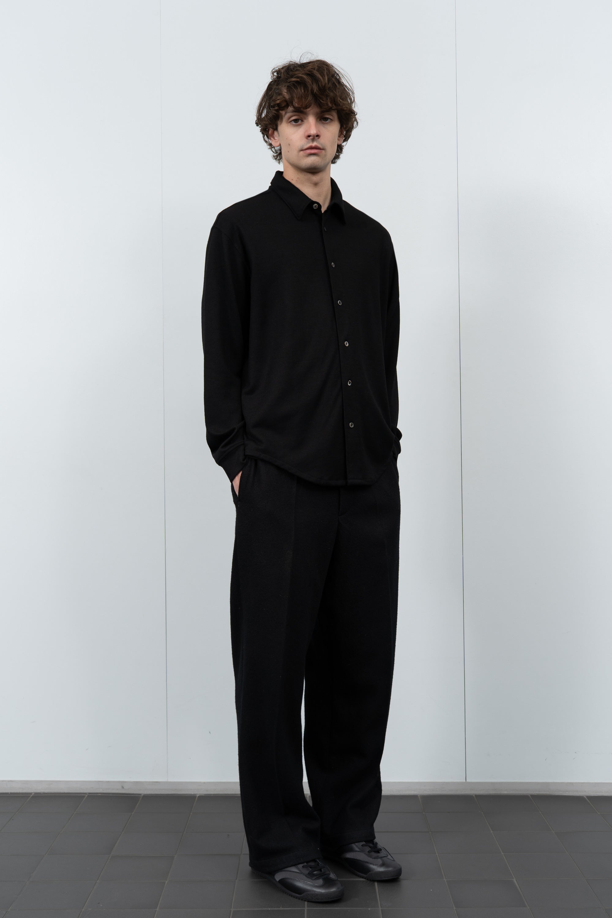 Model poses in LW444W Wool Button up  in black