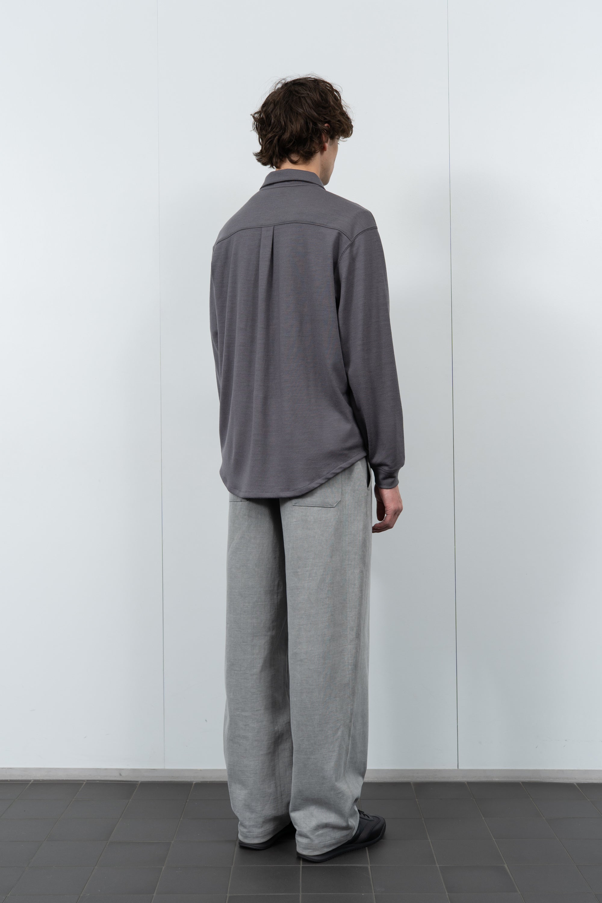 Model poses in LW444W Wool Button up  in slate grey