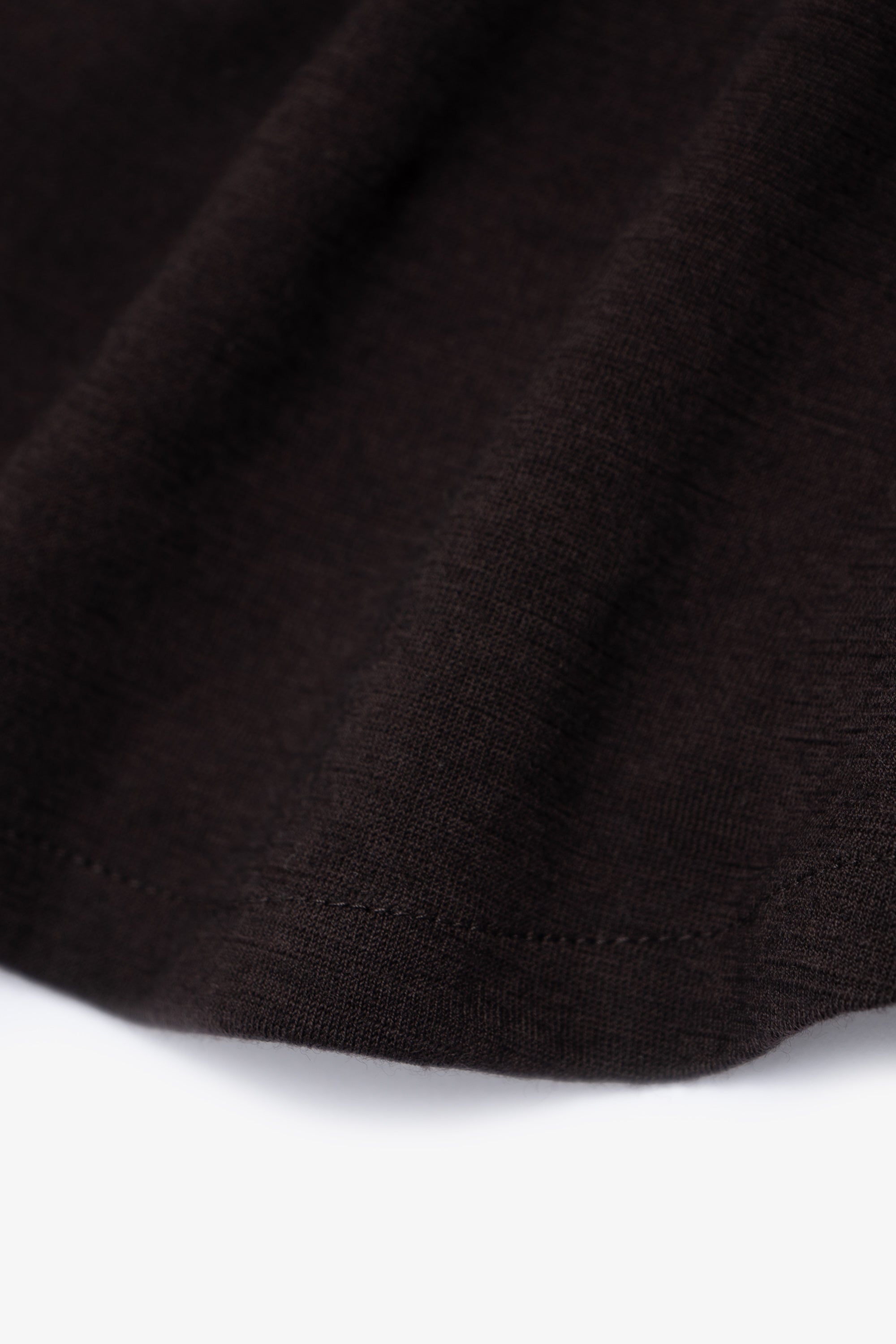 Close-up of hem of LW444W Wool Button up  in woodberry 