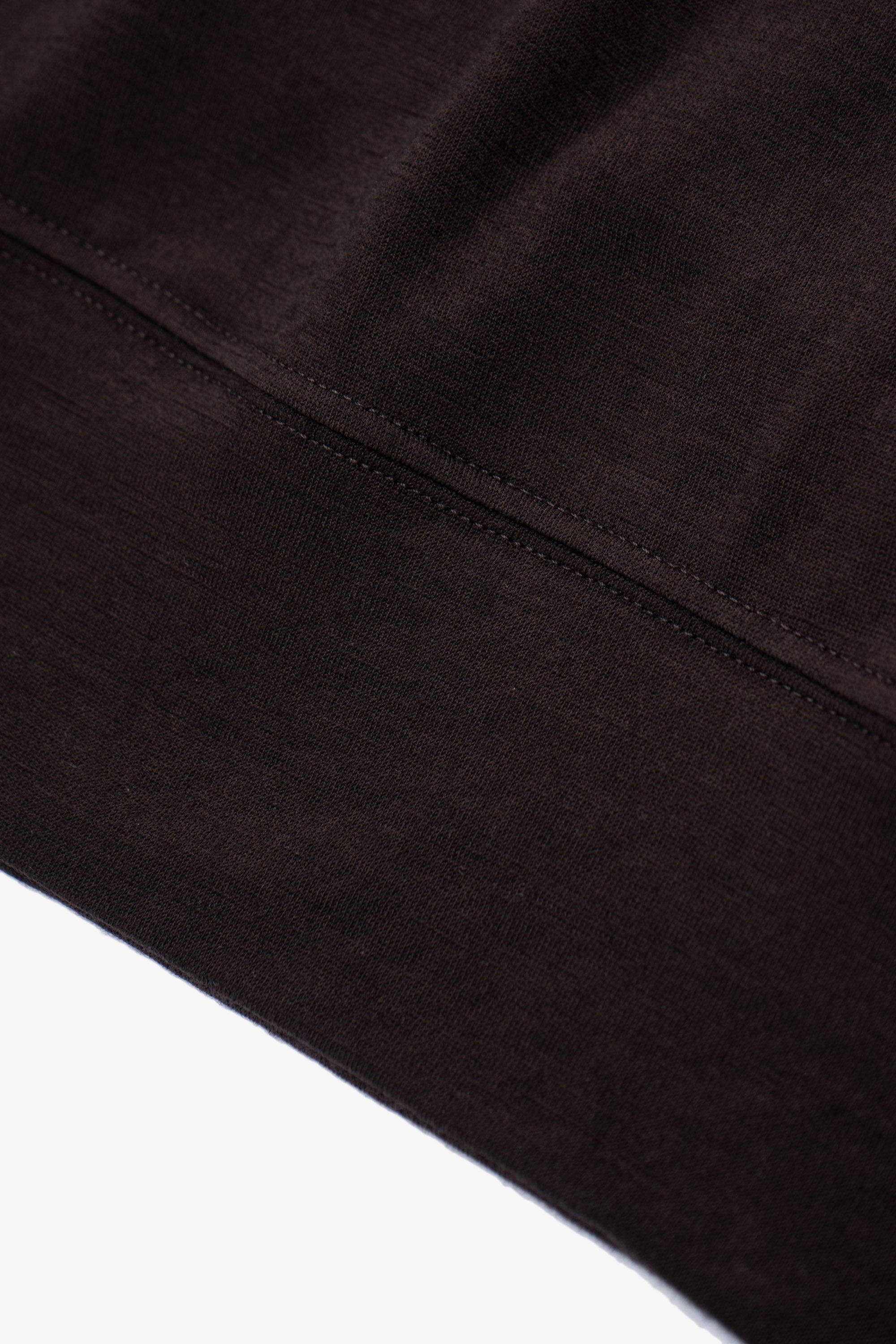 Close-up of waistband ribbing of LW601W Wool Jersey Sweater in woodberry 