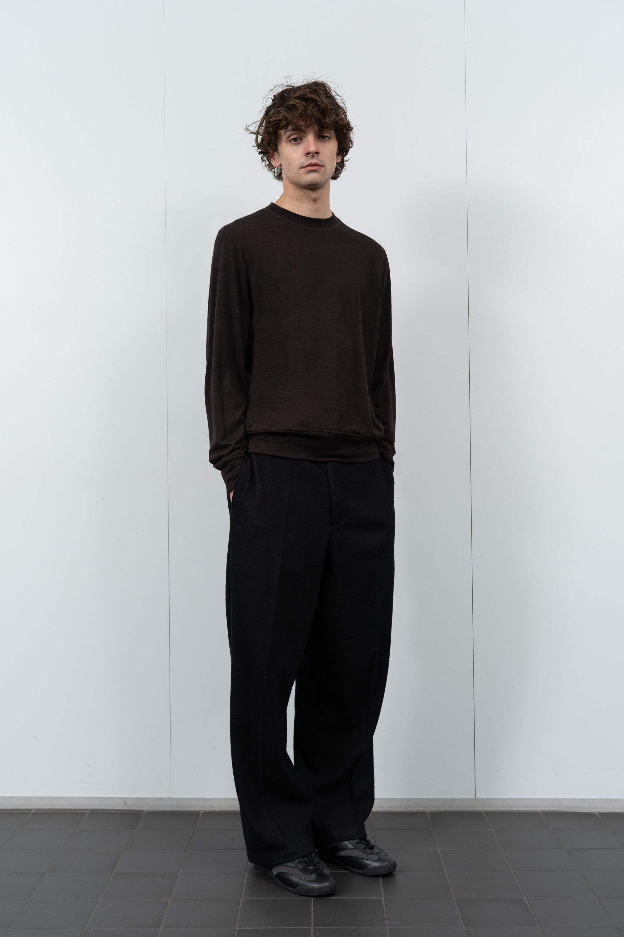 Model poses in LW601W Wool Jersey Sweater in Woodberry