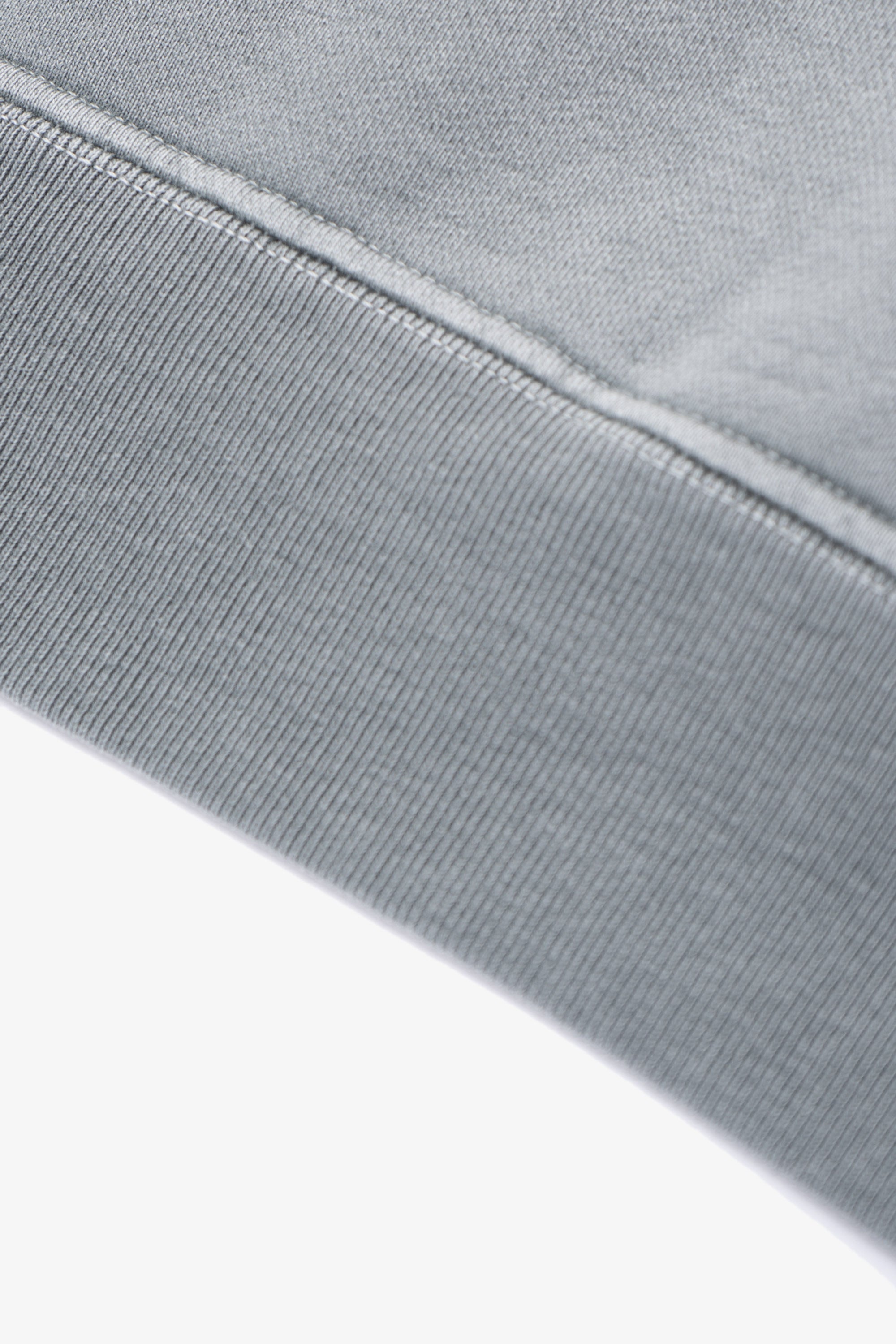 Close-up of waistband ribbing of LW620 Heavy Gusset Crewneck in pigment kelp