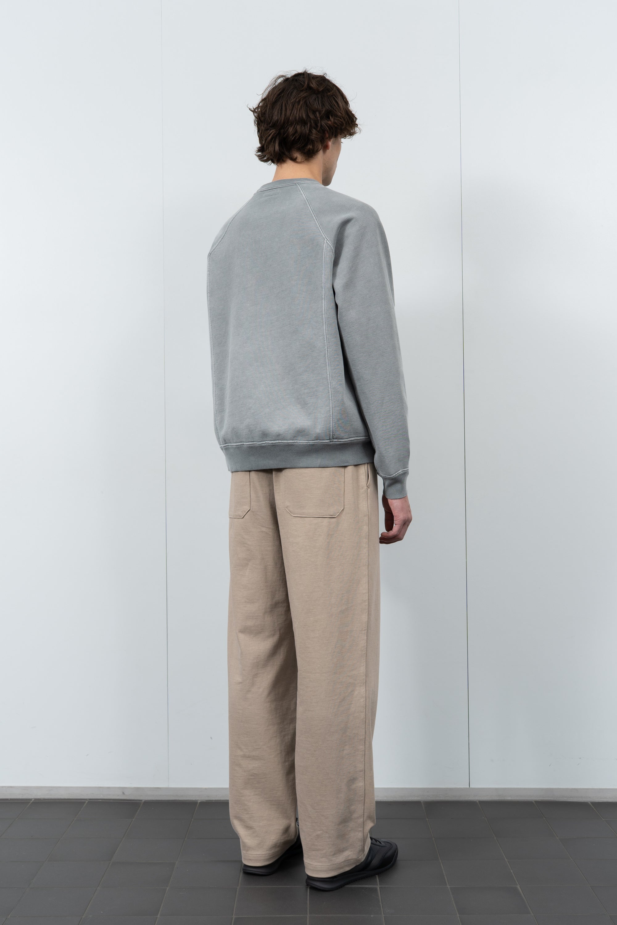 Model poses in LW620 Heavy Gusset Crewneck in pigment kelp