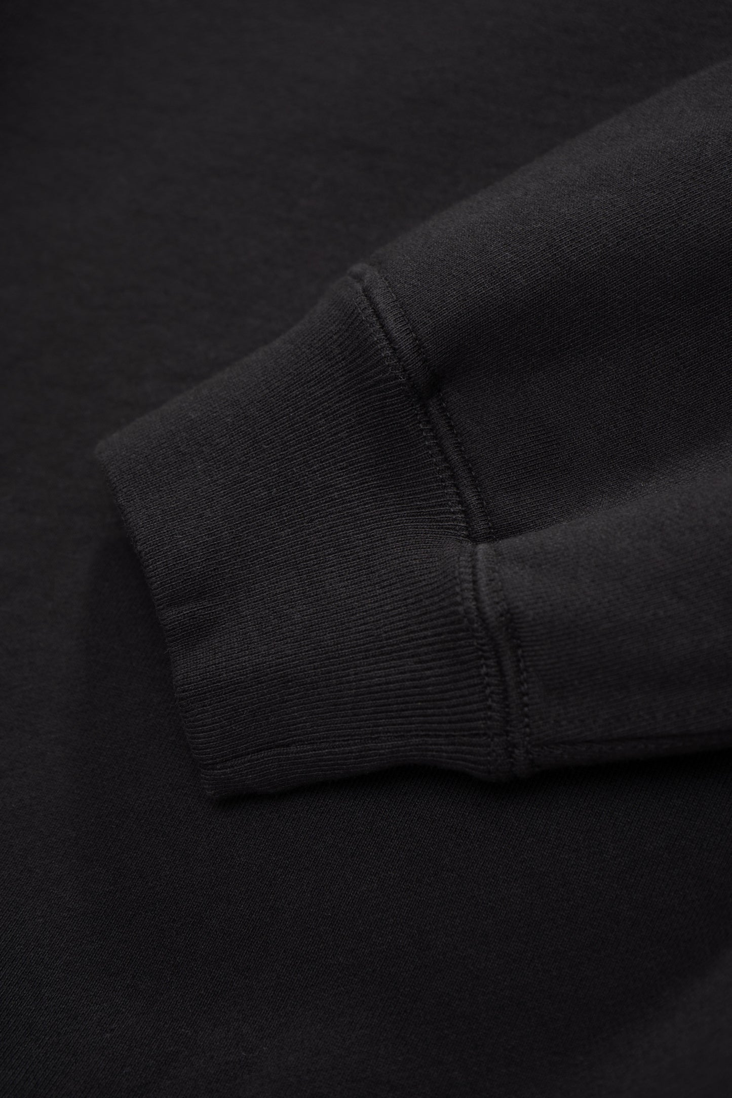 Close-up of cuff of LW620 Heavy Gusset Crewnenck in shadow