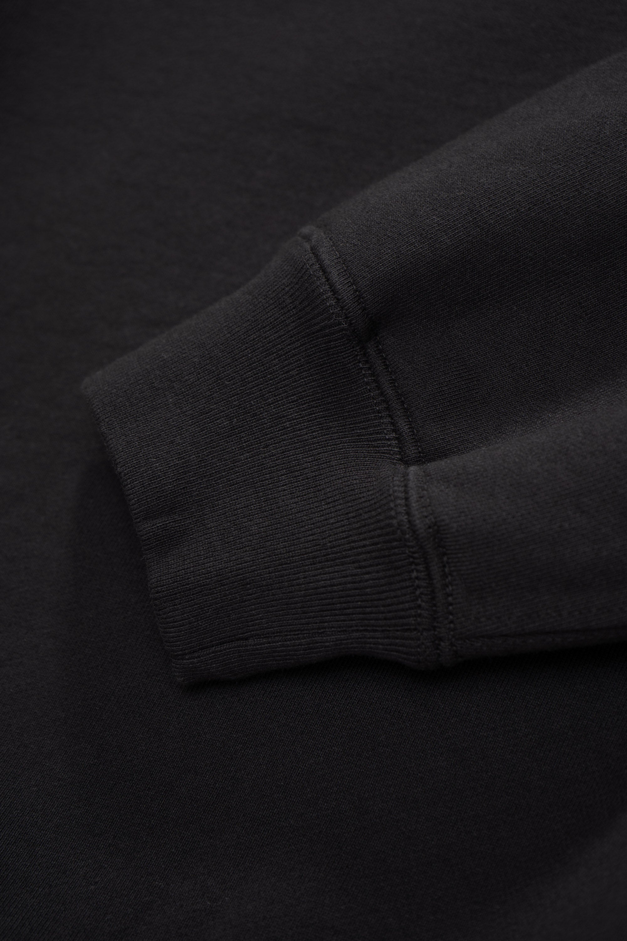 Close-up of cuff of LW620 Heavy Gusset Crewnenck in shadow