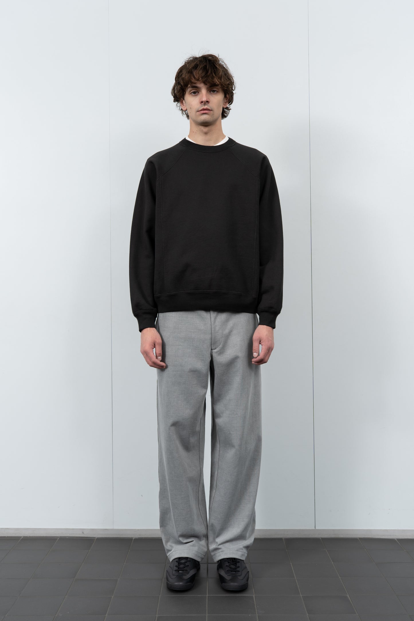 Model poses in LW620 Heavy Gusset Crewneck in shadow