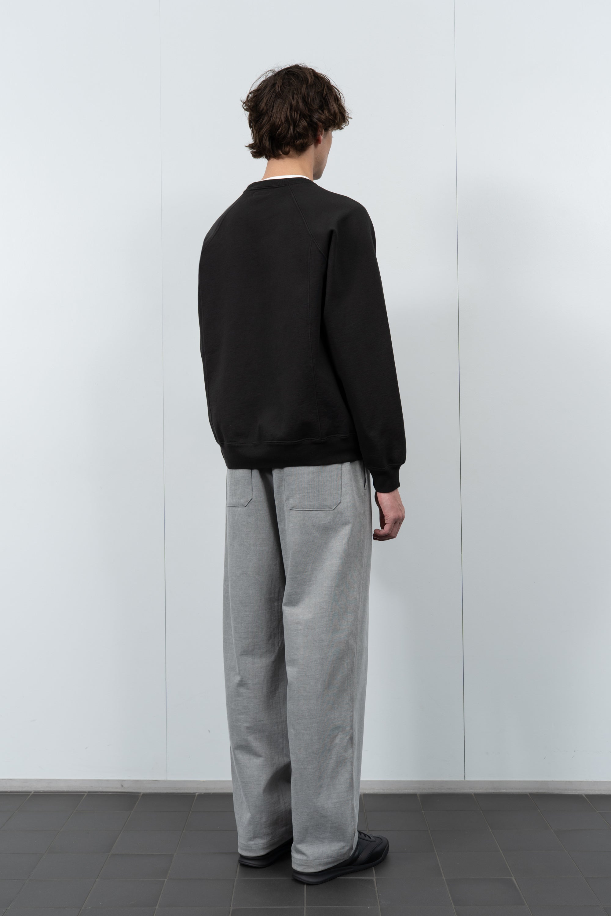 Model poses in LW620 Heavy Gusset Crewneck in shadow