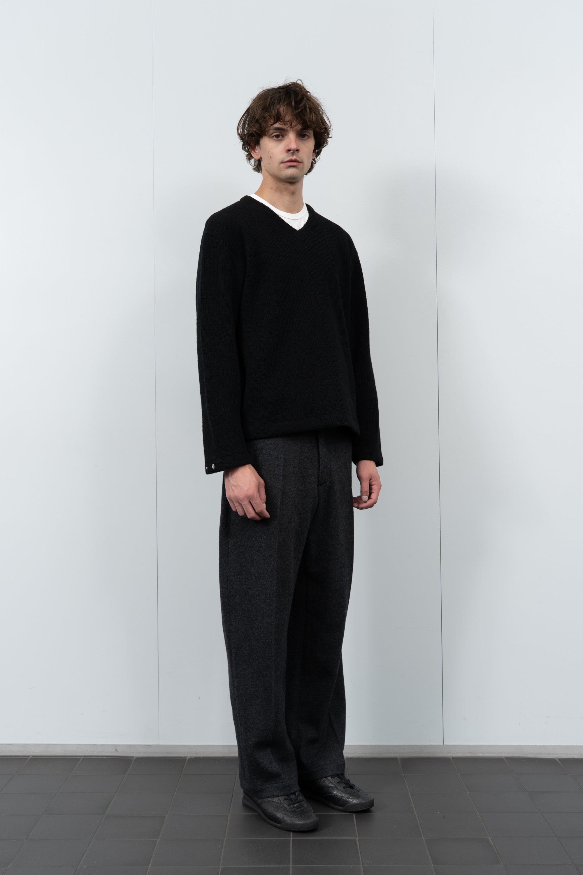 Model poses in LW770CW V Neck Snap Sweater in black