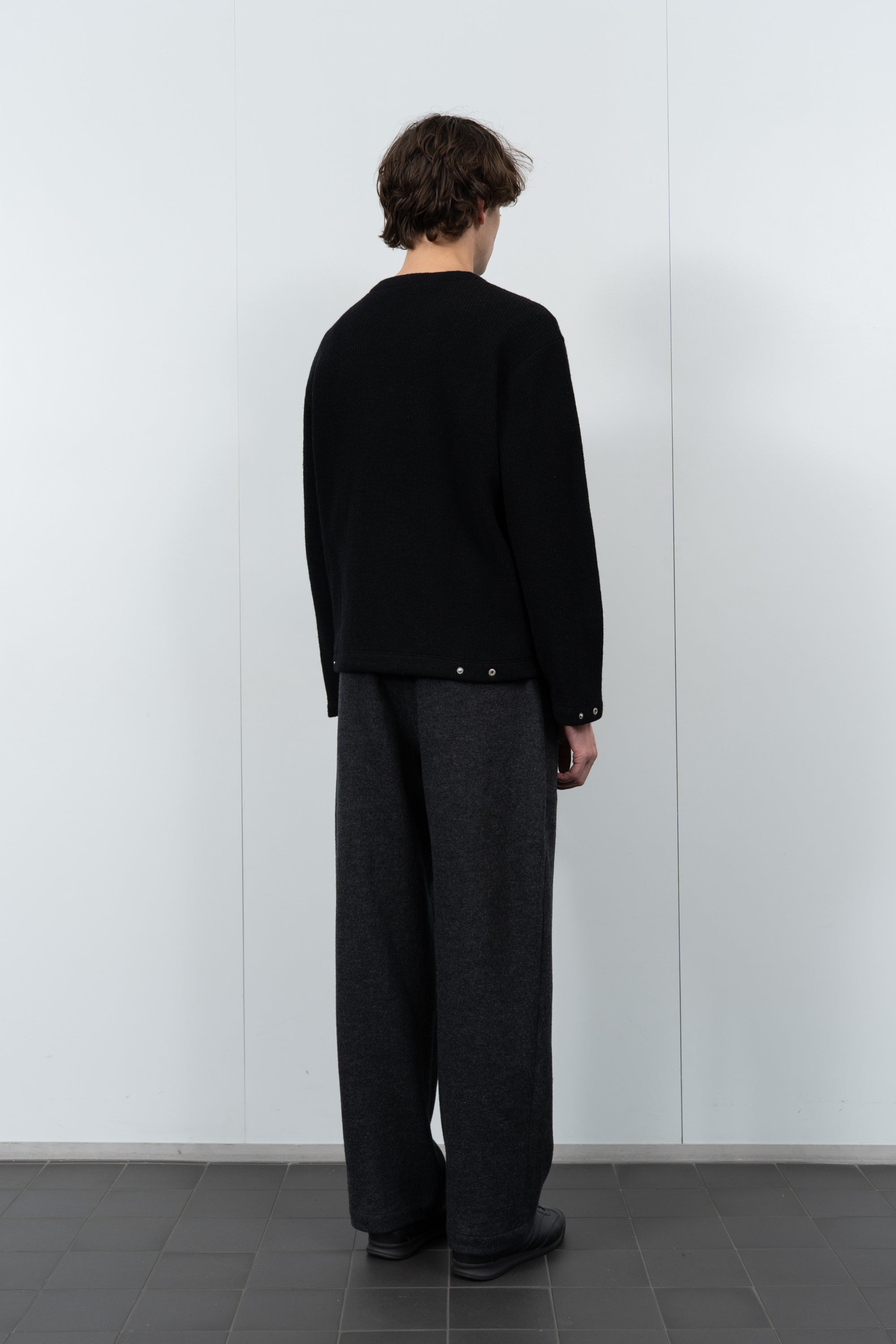 Model poses in LW770CW V Neck Snap Sweater in black