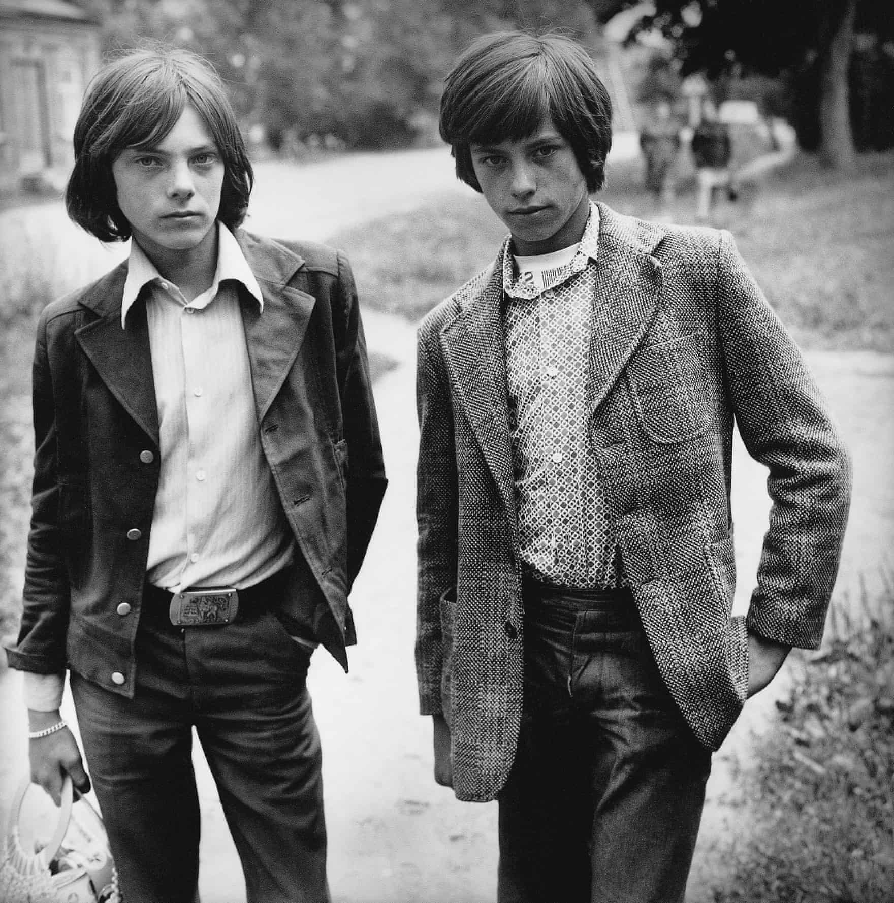 Photograph from Antanas Sutkus's photography book "People of Lithuania." Two young boys pose on a dirt path. 