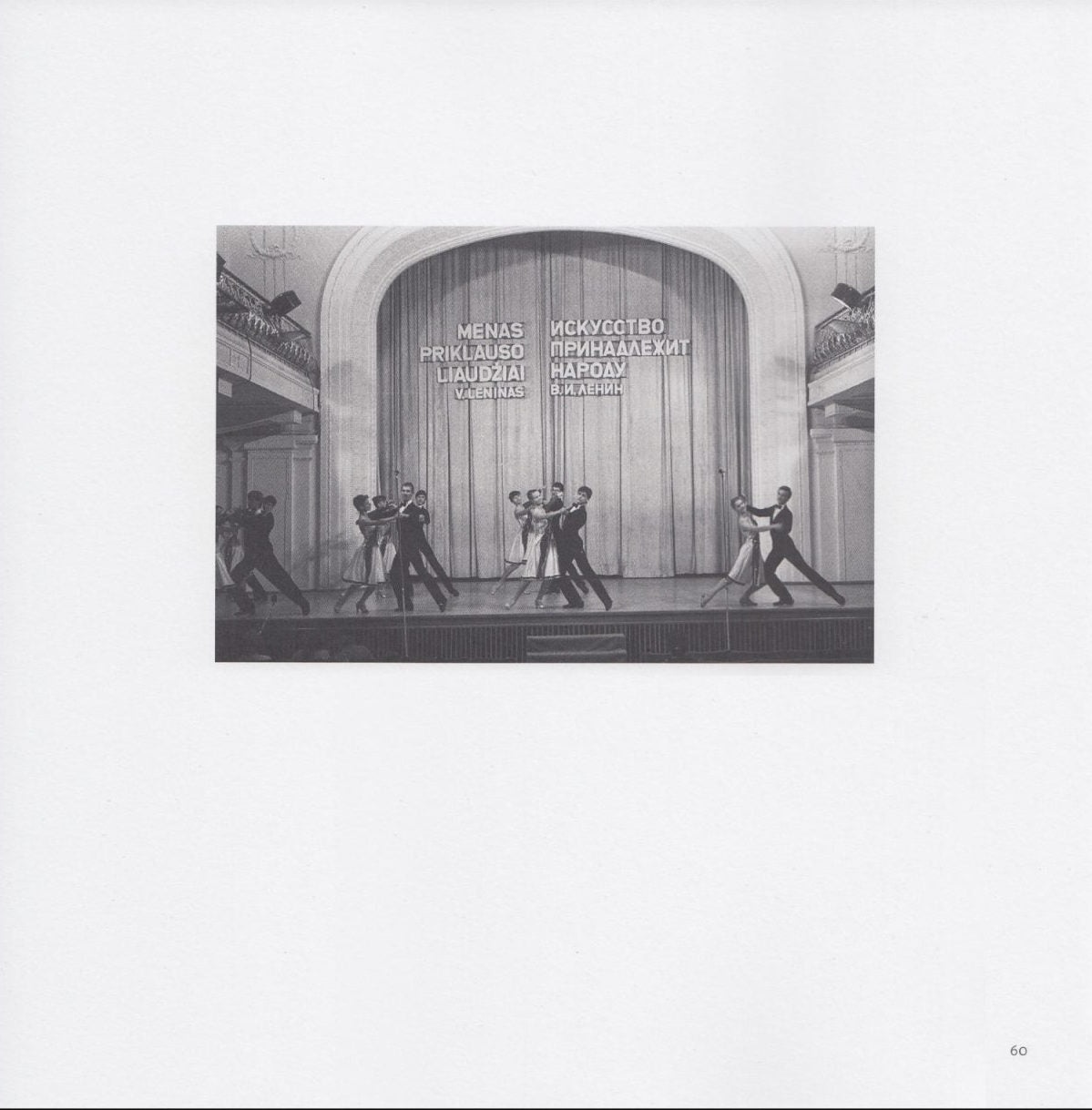 Still from Anton Seskus. igures dance on a stage, with Lithuanian text running above them against a curtain. 