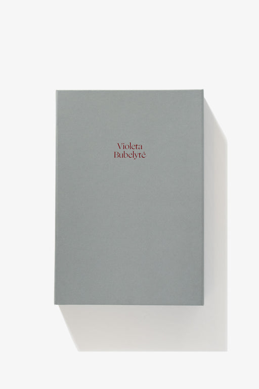 Full-length image of the cover of Violeta Bubelyte’s eponymous exhibition catalogue. A grey-blue background. The name “Violeta Bubelyte” printed in title case in serif font.