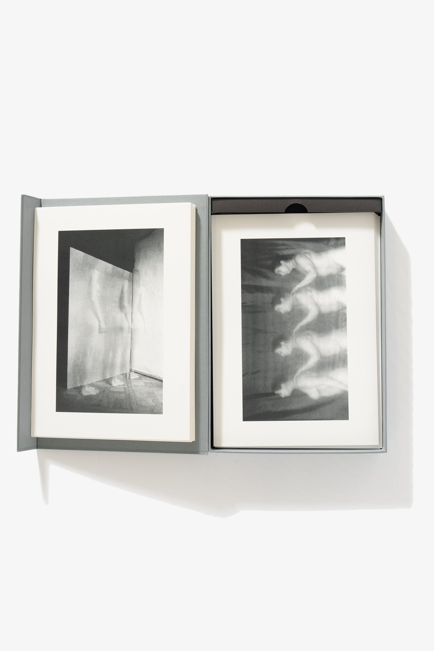 A full-length image of the collection opened. The left-side shows a single image of a nude figure, captured in stop motion, her body transparent. The right side shows the same woman captured in successive stationery positions, her hand posed as if on the shoulder of the one in front of her, captured in stop motion.