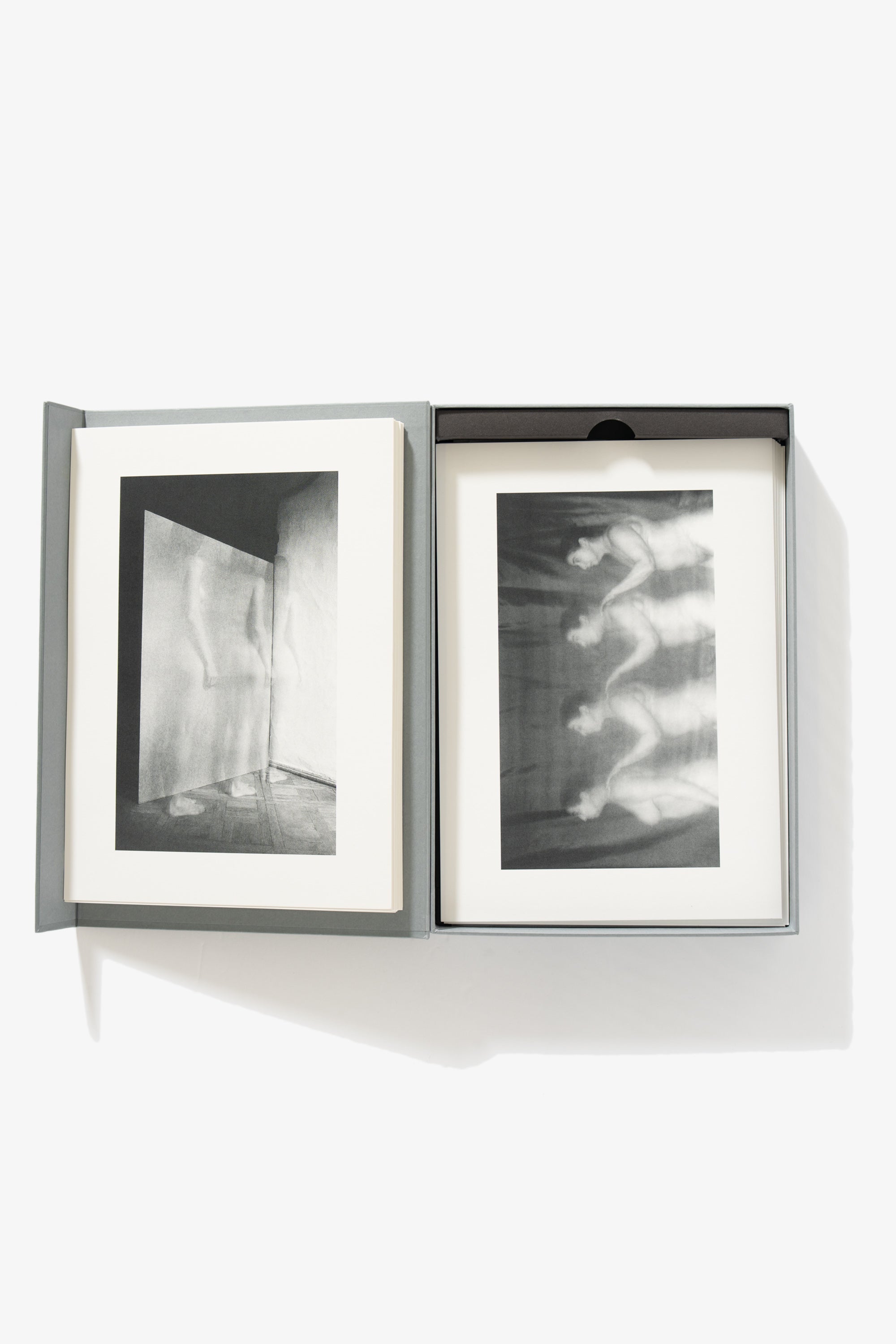 A full-length image of the collection opened. The left-side shows a single image of a nude figure, captured in stop motion, her body transparent. The right side shows the same woman captured in successive stationery positions, her hand posed as if on the shoulder of the one in front of her, captured in stop motion.