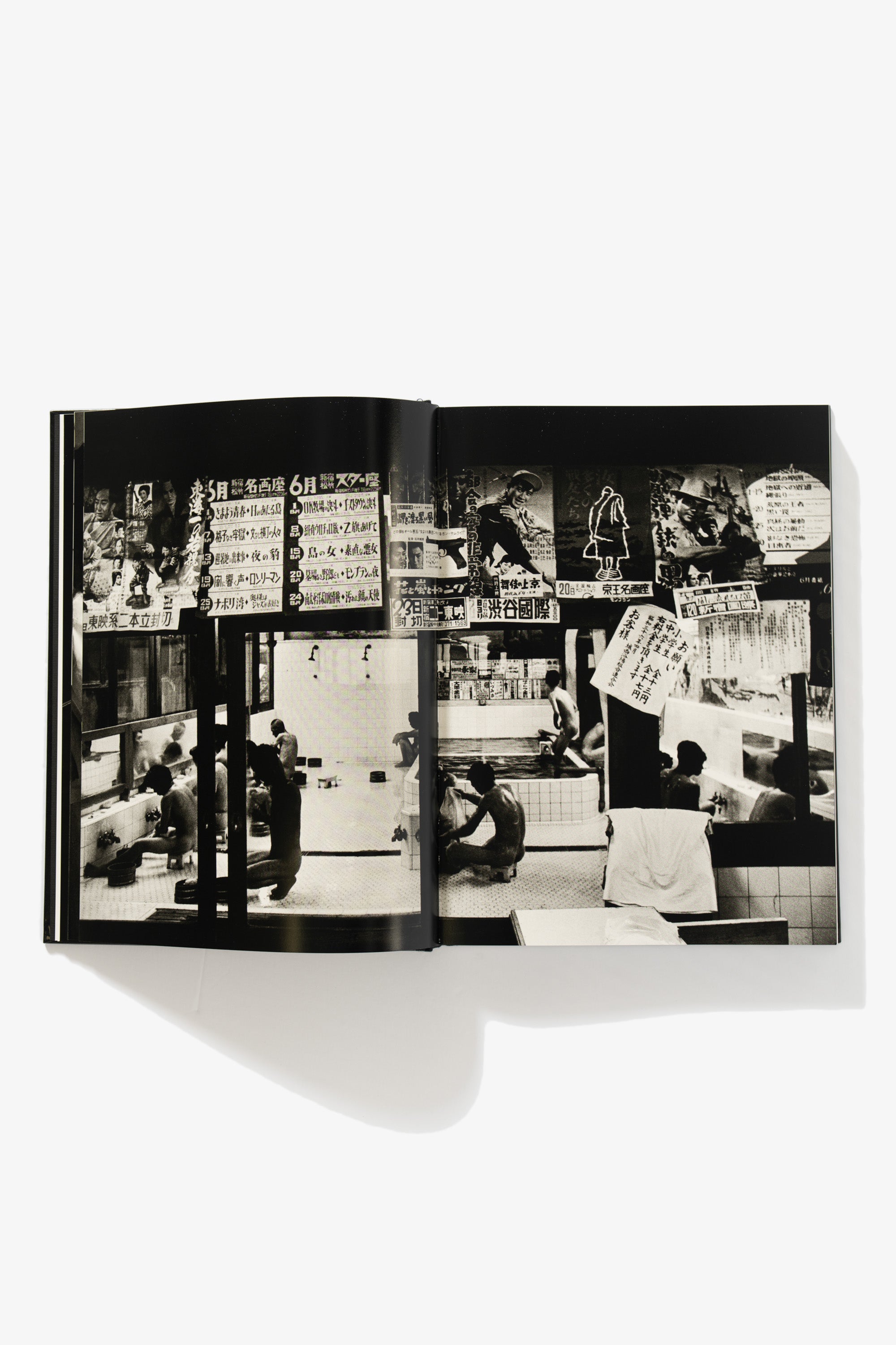 Full-length spread of Tokyo 1961. Various images of Tokyo bath houses occupy both pages of men bathing, signage, and towels. 